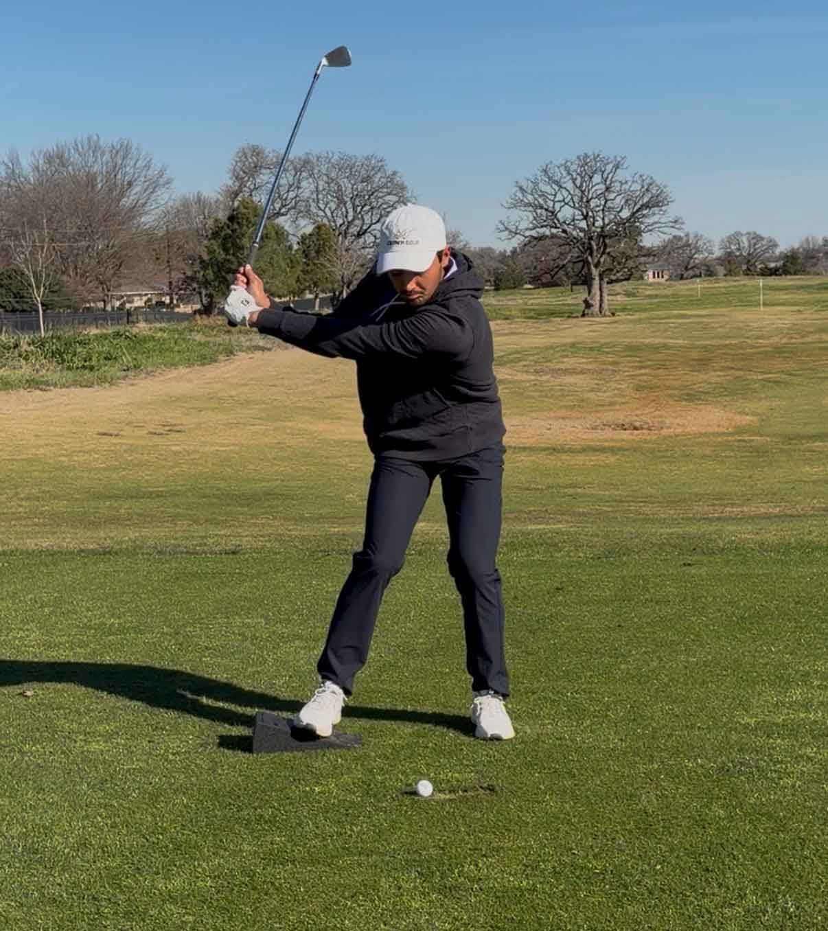 hudson weibel swings with wedge underneath his trail foot