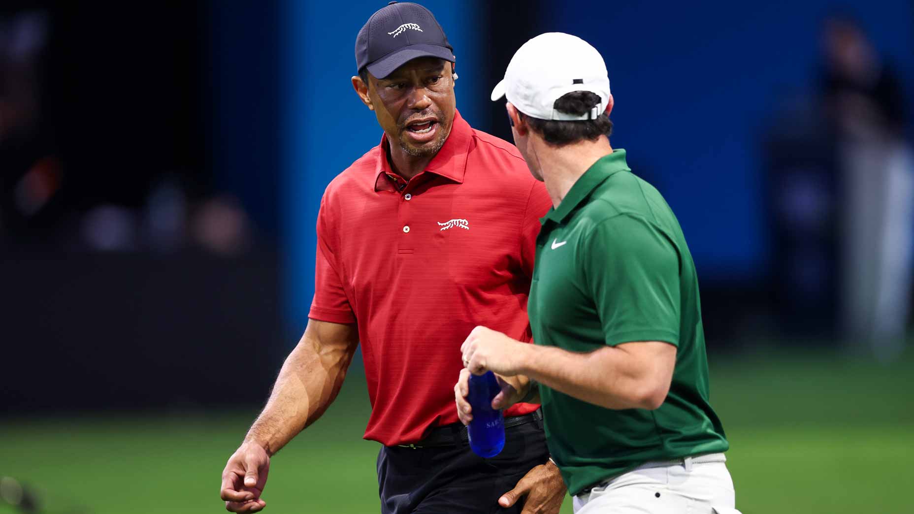 Tiger Woods talks with Rory McIlroy during a TGL match at SoFi Center.