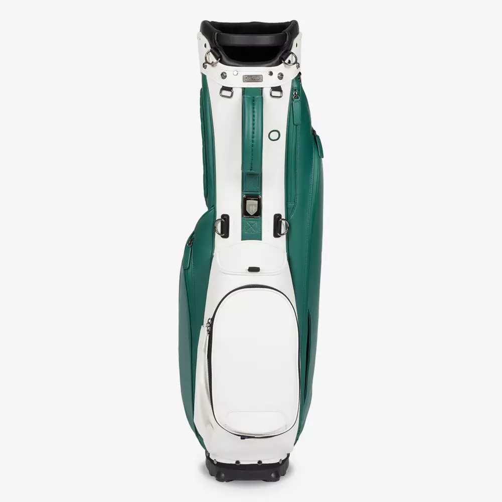 A white and green golf bag standing upright with multiple zippered pockets and a black handle on top&mdash;an ideal choice for those seeking the best golf bags 2026 for carrying clubs and accessories.