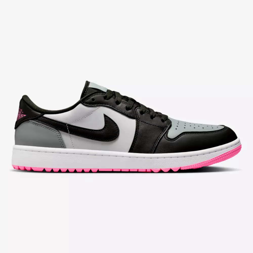 A Nike Air Jordan 1 Low sneaker with black, grey, and white leather panels, a black Swoosh, and a pink outsole&mdash;perfect for those seeking the best Jordan golf shoes with style. Features include black laces, a white midsole, and perforated toe box.