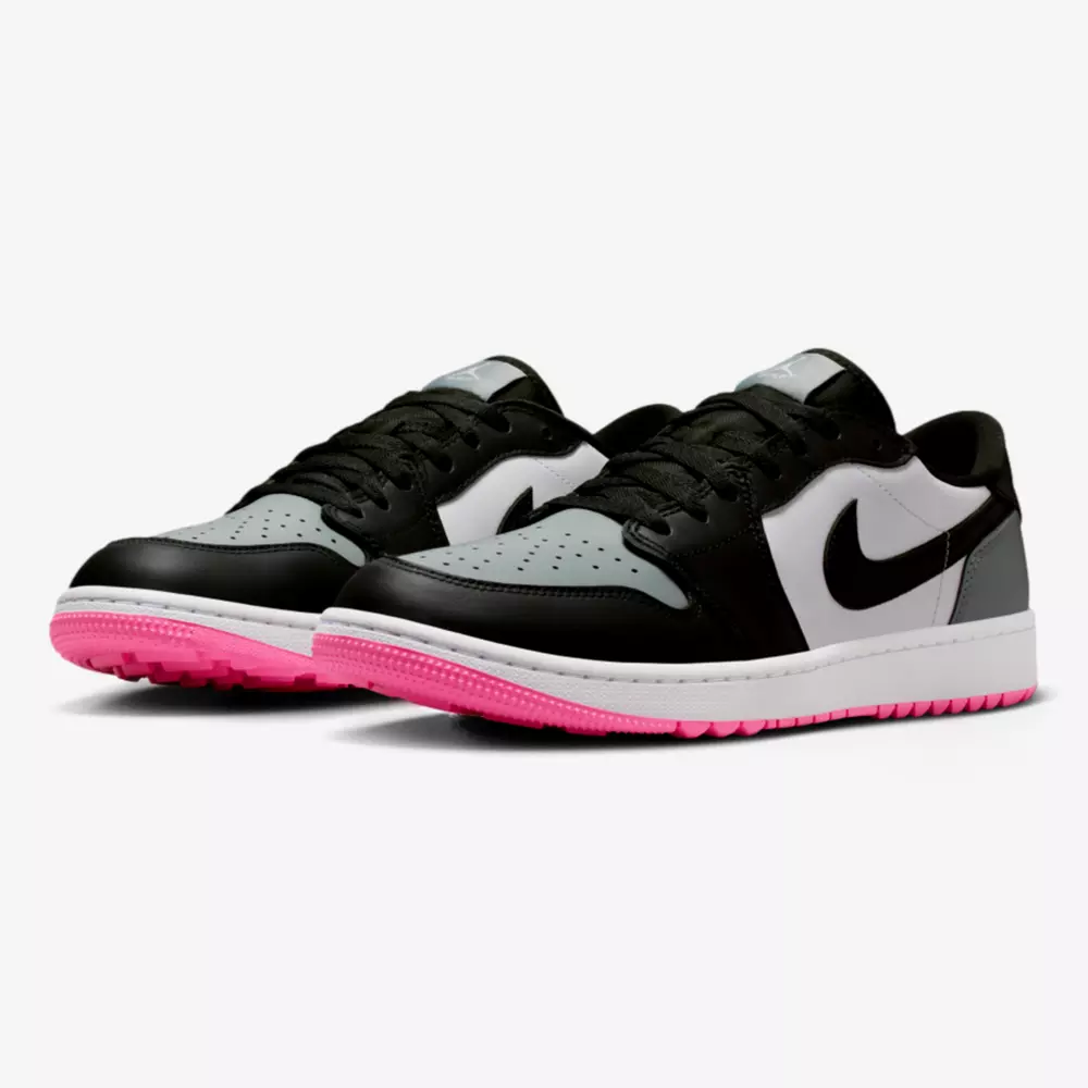 A pair of Nike Air Jordan low-top sneakers with black, white, and gray uppers, black swooshes, and bright pink outsoles&mdash;perfect for those seeking the best Jordan golf shoes&mdash;displayed on a white background.