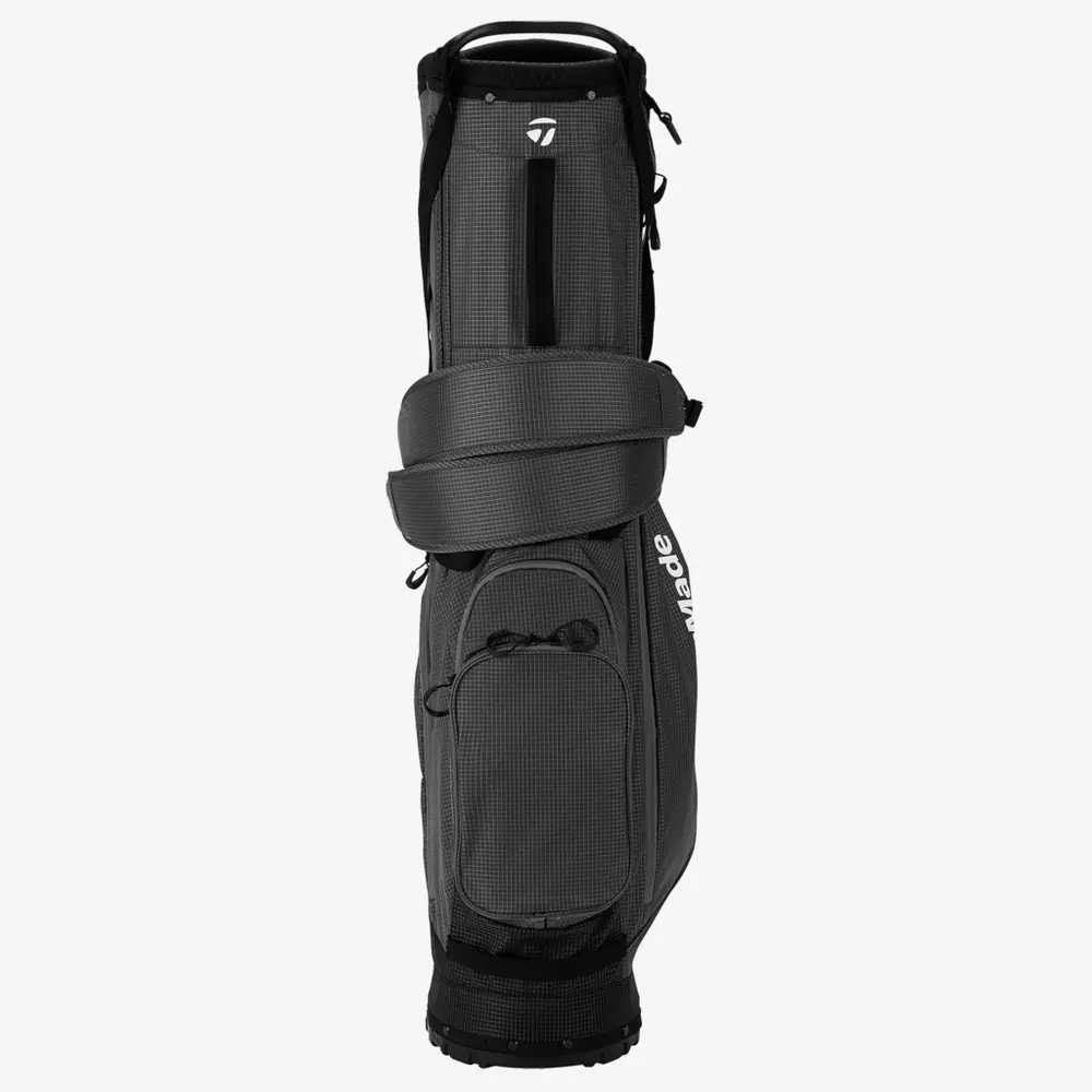 A black and gray golf bag with zippered pockets, shoulder straps, and the word &ldquo;TaylorMade&rdquo; printed vertically in white on the side&mdash;an ideal pick for anyone searching for the best golf bags 2026.