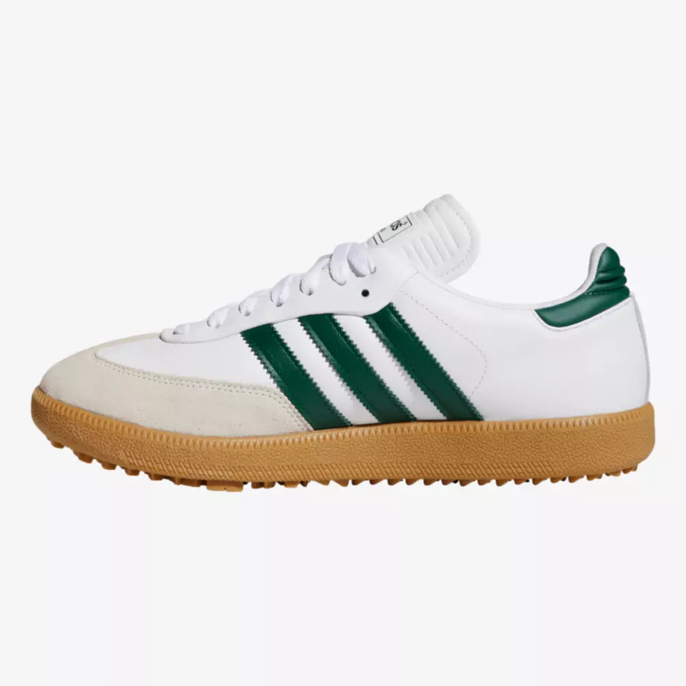 A white sneaker with green stripes, green heel detail, white laces, and a tan rubber sole&mdash;an inspired look reminiscent of the best women's golf shoes 2026&mdash;shown from the side on a plain white background.