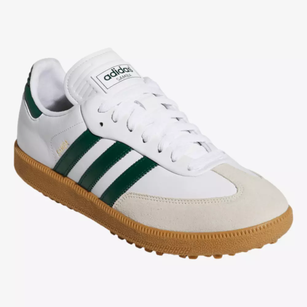 A white Adidas Samba sneaker with green stripes, beige suede toe, and a brown gum sole&mdash;an iconic style that inspires the best women's golf shoes 2026&mdash;displayed on a white background.