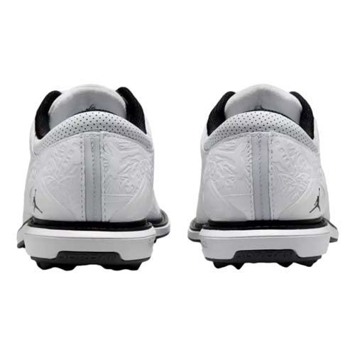 White athletic shoes with black soles are shown from the back. Featuring the Jumpman logo near the heel, these best Jordan golf shoes boast a subtle textured pattern and black interior lining for both style and comfort.