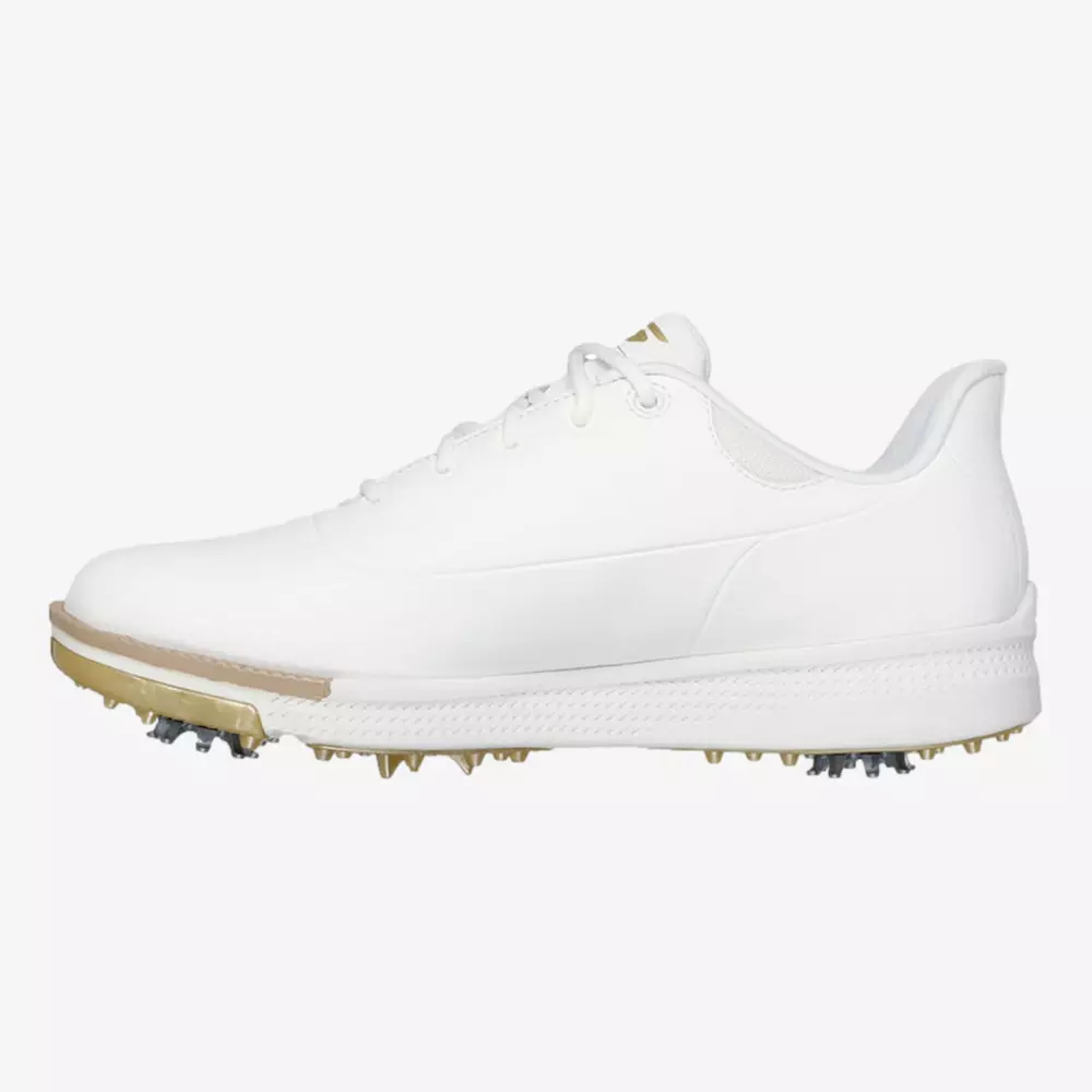 A white low-top golf shoe with a beige sole and metal spikes, viewed from the side against a plain background&mdash;an elegant choice for those seeking the best women's golf shoes 2026.