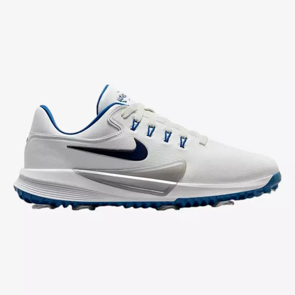 White athletic shoe with blue accents, including a blue Nike swoosh logo, blue eyelets, and a blue and white sole. The textured sole offers excellent traction, making it one of the best golf shoes 2026 has to offer.