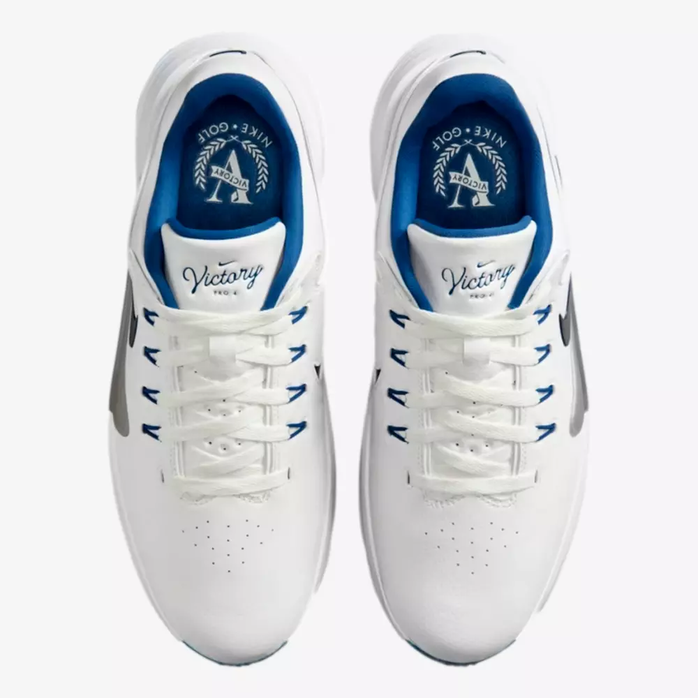 Top view of a pair of white Nike golf shoes with blue inner lining, white laces, perforated toe area, and Victory branding on the insoles&mdash;an early contender for the best golf shoes 2026.