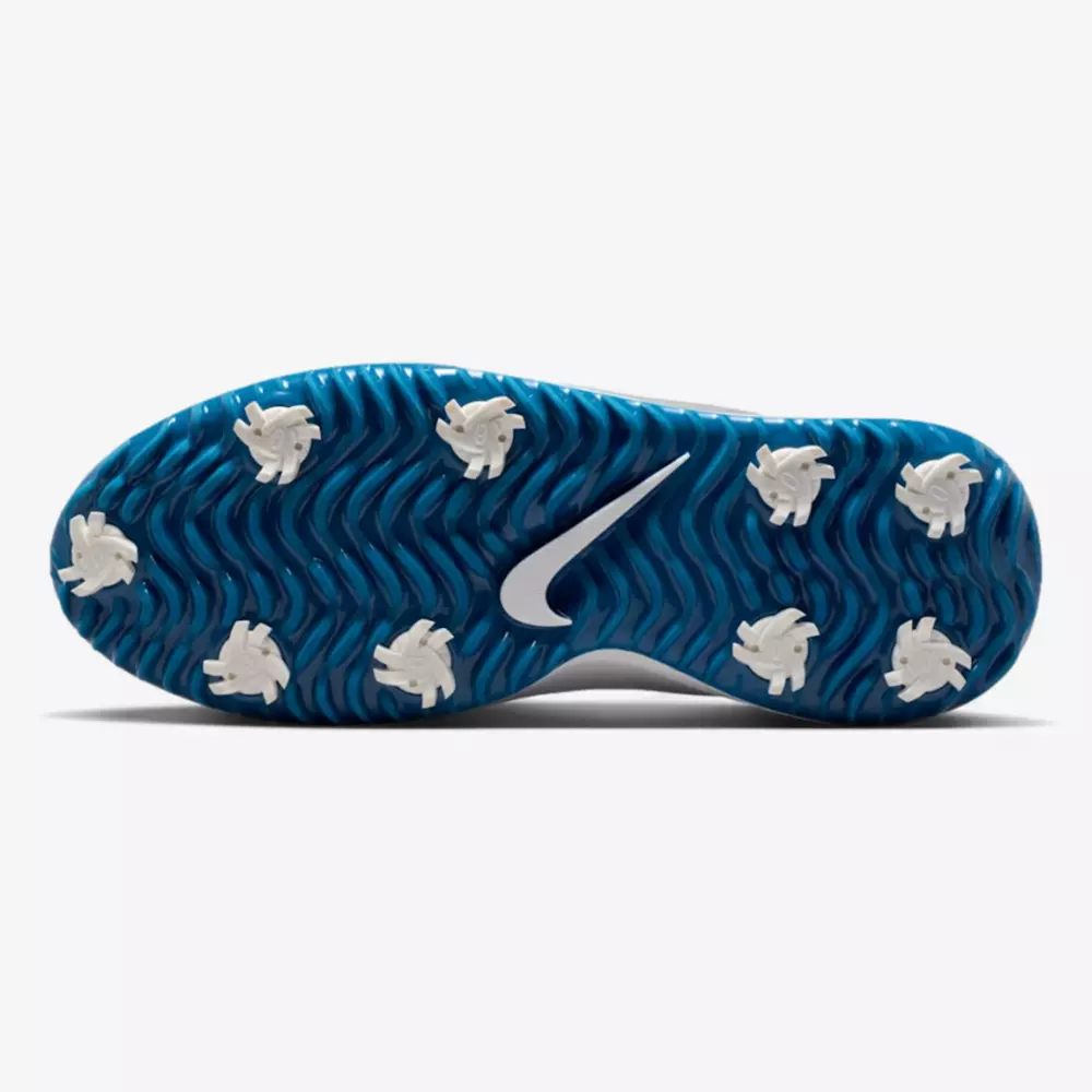 The image shows the sole of a golf shoe with a blue, wavy-textured base, eight white cleats, and a white Nike swoosh logo in the center&mdash;an innovative design that could set the standard for the best golf shoes 2026.