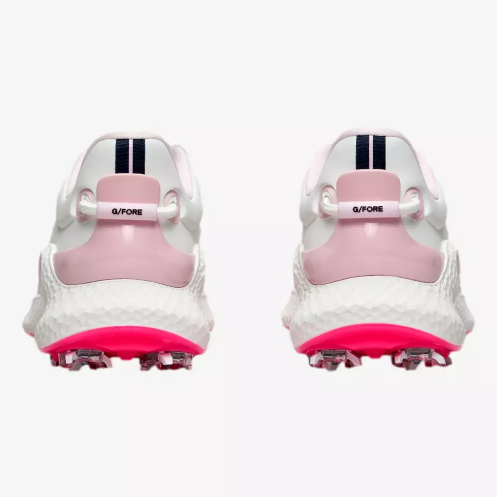 Back view of a pair of white athletic shoes with pink accents, black vertical stripes on the heel, and bright pink spiked soles for grip&mdash;perfect contenders for best golf shoes 2026. The brand &ldquo;G/FORE&rdquo; is visible on the heel tabs.