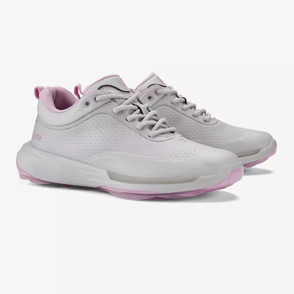 A pair of white athletic sneakers with light pink accents on the sole, inner lining, and heel tab. Featuring a mesh upper and lace-up closure, these shoes offer a modern, sporty design inspired by the best golf shoes 2026.