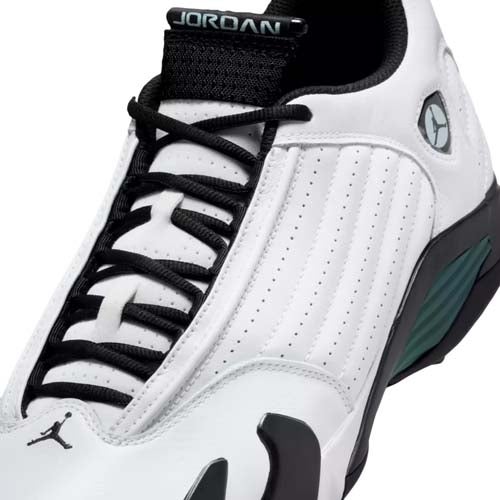 Close-up of a white and black Air Jordan sneaker with black laces, a small Jumpman logo on the toe, and the JORDAN label on the tongue. With green and grey accents, this pair channels the style seen in some of the best Jordan golf shoes.