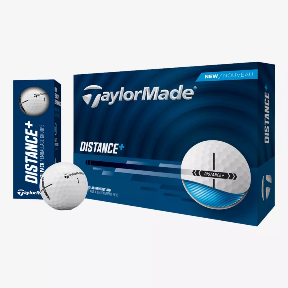 A box of TaylorMade Distance+ golf balls is shown with a smaller pack beside it and two balls in front&mdash;one featuring a black alignment aid line. The blue and white packaging pairs well with the best golf shoes 2026 for your next round.
