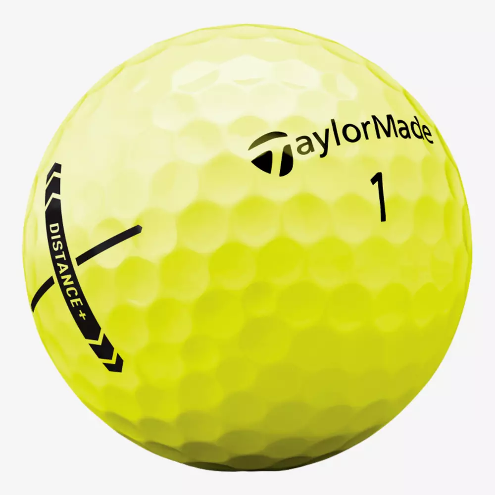 A close-up of a yellow TaylorMade golf ball with dimpled texture, the number 1, and black graphics including the word DISTANCE+ and the TaylorMade logo&mdash;perfect for pairing with the best golf shoes 2026 on your next round.