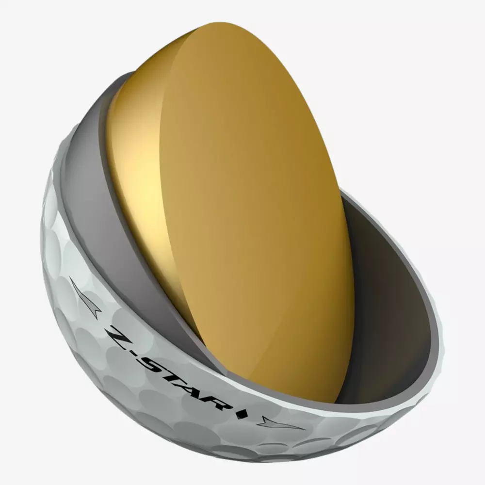 A Z-STAR golf ball, considered among the best golf balls 2026, is cut in half to reveal its golden inner core and gray layer inside the dimpled white outer shell.