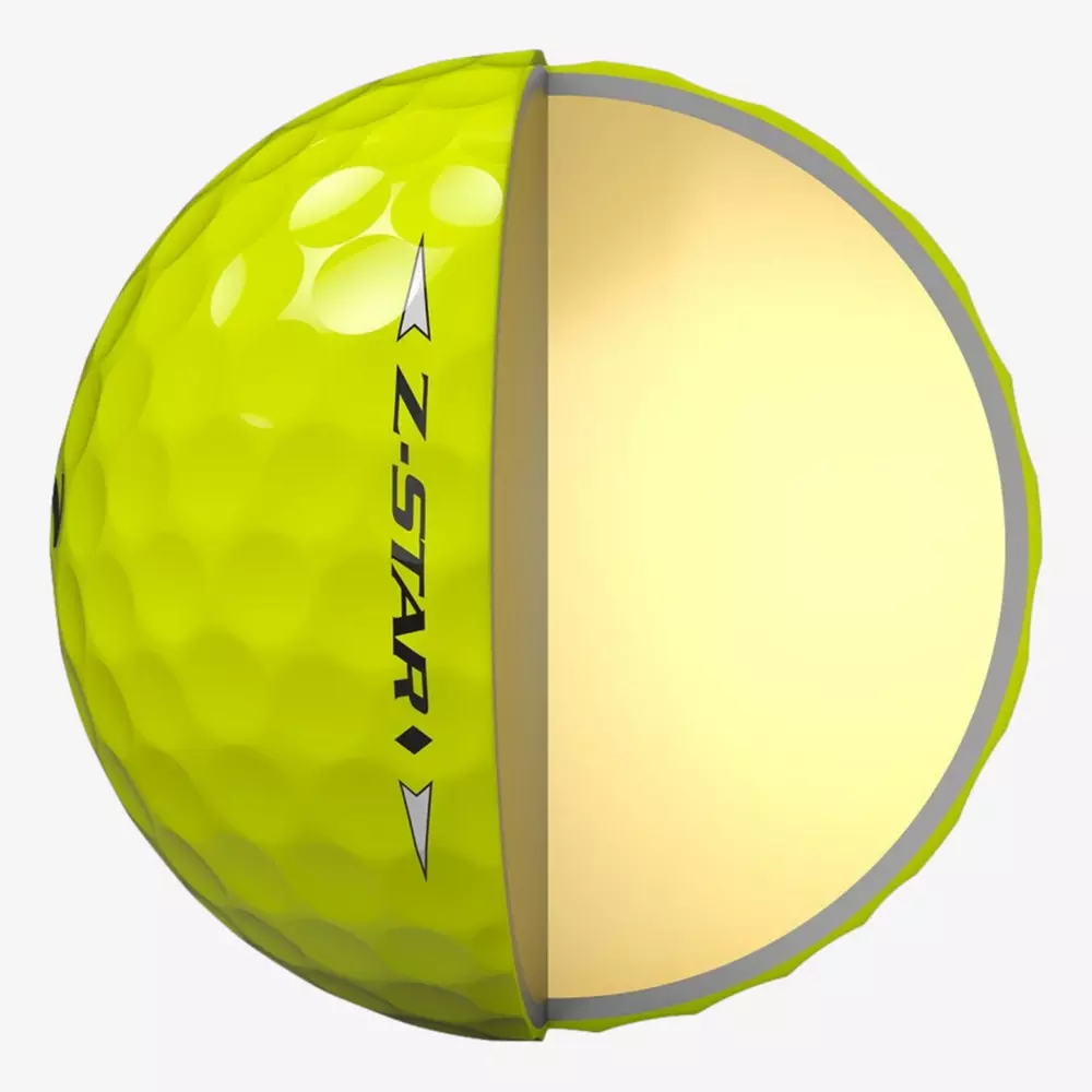 A yellow golf ball labeled Z-STAR is shown in half; the left side displays the dimpled exterior, while the right half reveals a smooth, solid inner core&mdash;an example of innovation seen in the best golf balls 2026.