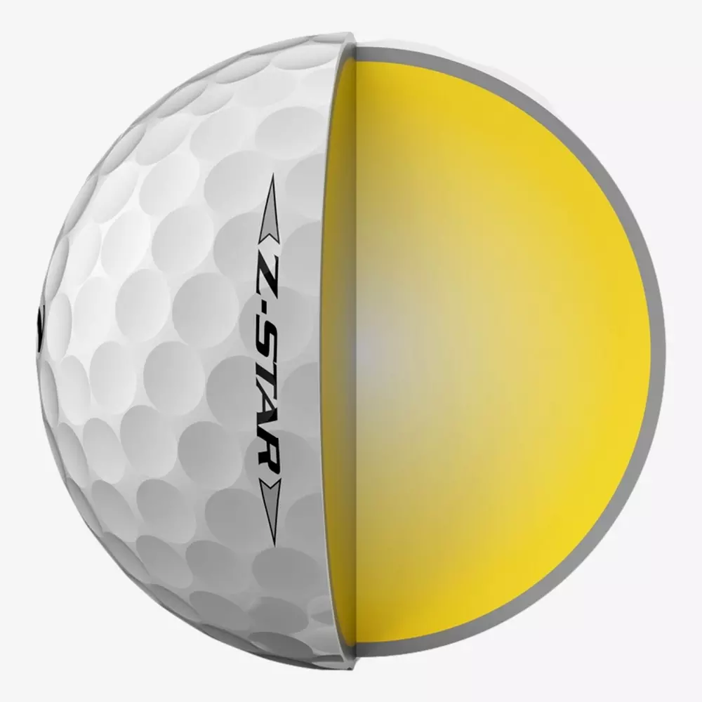 A golf ball labeled Z-STAR is shown cut in half, revealing its yellow inner core and textured white outer layer with dimples&mdash;the perfect companion for those searching for the best golf shoes 2026.