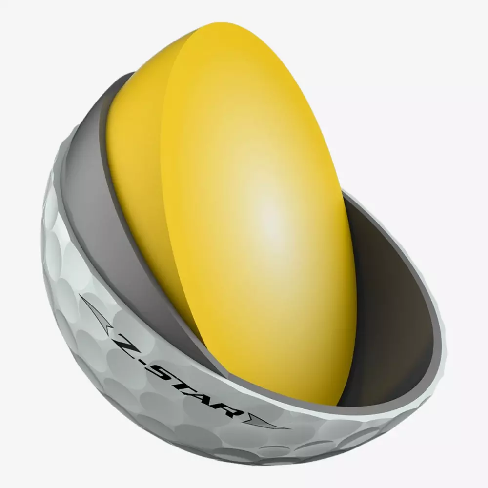 A cross-section of a Z-Star golf ball, showing the white dimpled outer layer, a dark inner layer, and a large yellow core&mdash;perfect for those aiming to match their skills and gear with the best golf shoes 2026 has to offer.