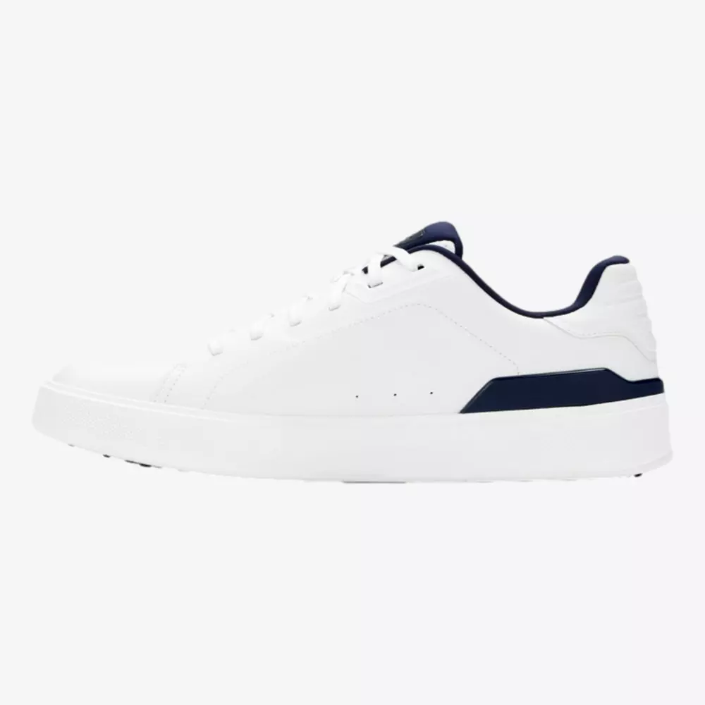 A white low-top sneaker with a navy blue accent on the heel and collar, shown in a side profile view against a plain background&mdash;perfect style for those seeking the best golf shoes 2026 has to offer.