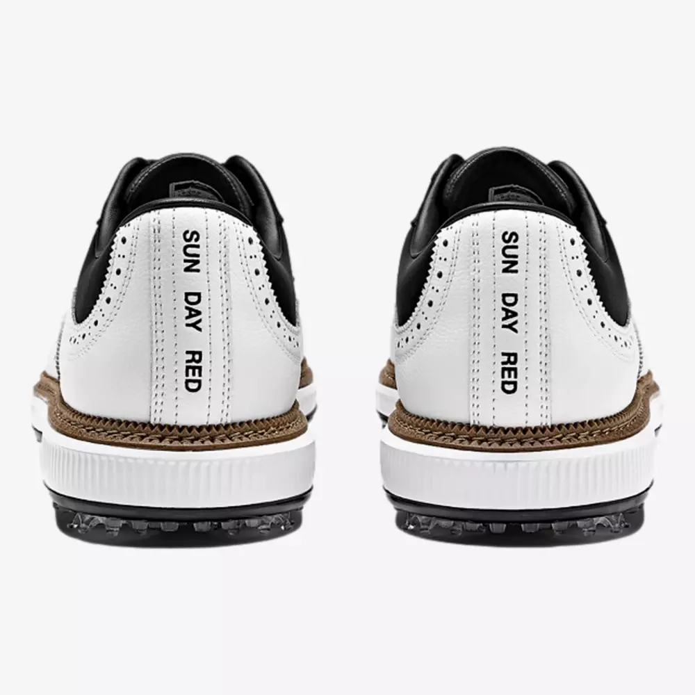 A pair of white and black sneakers, inspired by the best Jordan golf shoes, is shown from the back. On each heel, the words SUN DAY RED are printed vertically in bold black capital letters.