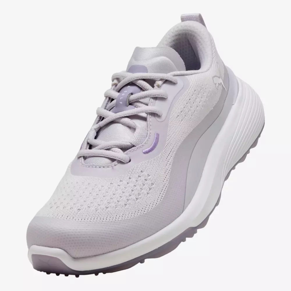 A light grey and lavender athletic shoe with a mesh upper, lace-up closure, and a thick, cushioned sole. Subtle branding and a sleek, modern design make it one of the best women's golf shoes 2026 has to offer.