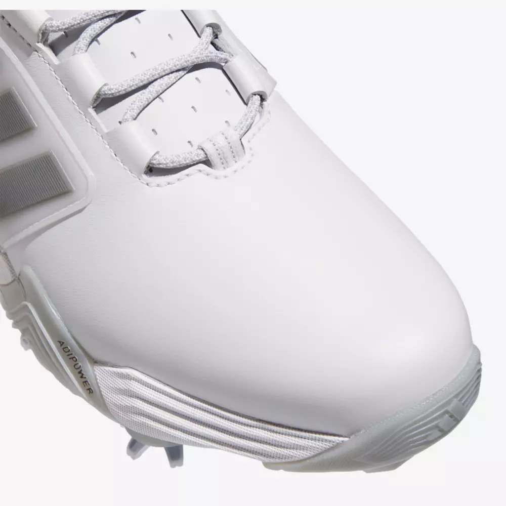 Close-up of the front and side of a white athletic shoe with gray laces and textured gray sole, showing detailed stitching and part of the Adidas logo on the side&mdash;perfect for those seeking performance similar to the best Jordan golf shoes.