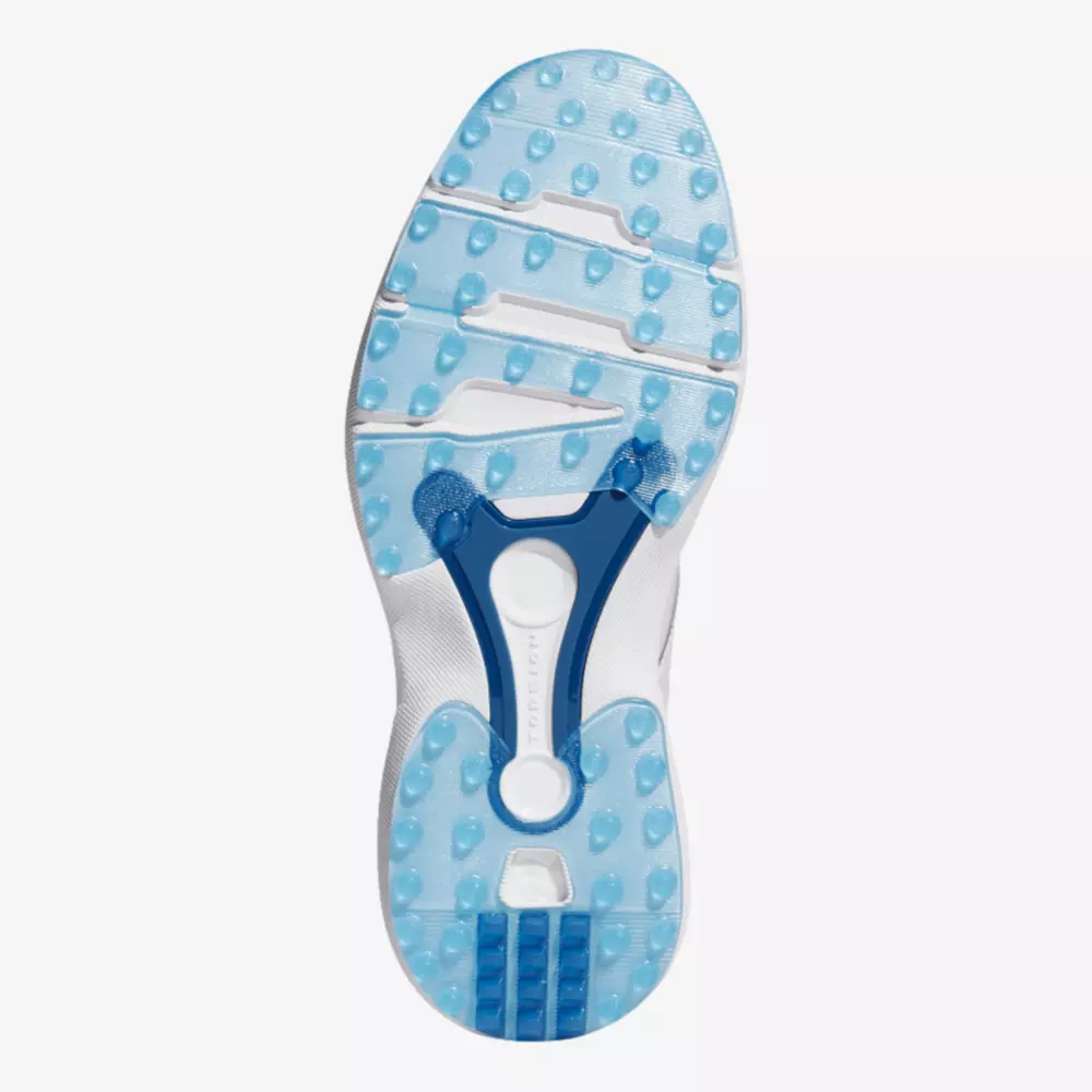 The image shows the sole of a white athletic shoe, inspired by the best Jordan golf shoes, featuring a translucent blue and white tread with small round grips and blue structural elements for support.