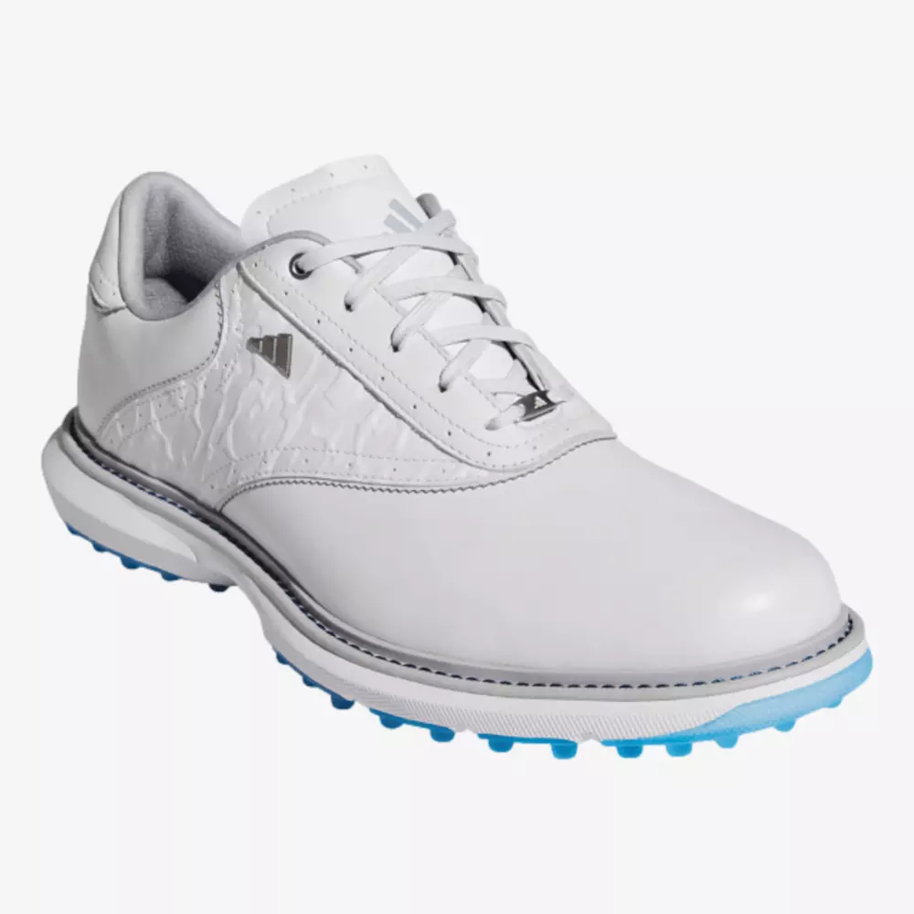 A white athletic shoe with light blue spikes on the sole, white laces, and a subtle gray logo on the side&mdash;crafted for sports or golf and inspired by the best Jordan golf shoes.
