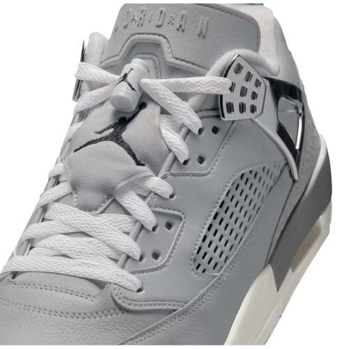 A close-up view of a gray Air Jordan sneaker, featuring detailed laces, a black Jumpman logo on the tongue, and silver accents—showcasing the premium design often seen in the best Jordan golf shoes.
