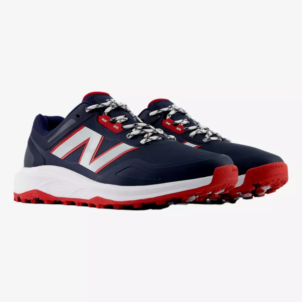 A pair of navy blue athletic sneakers with red and white accents, large white N logos on the sides, red soles, and patterned white and black laces&mdash;perfect for those seeking style beyond the best Jordan golf shoes&mdash;displayed on a white background.