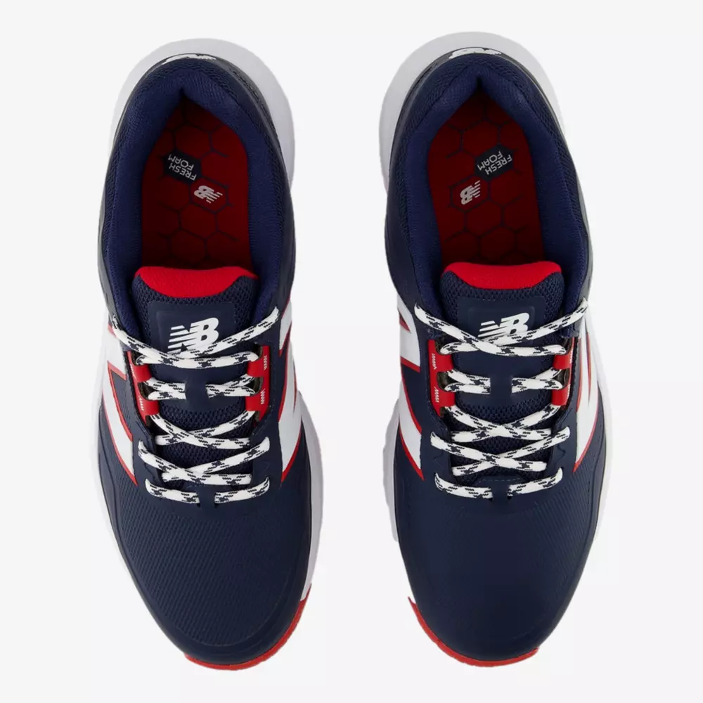 Top view of a pair of navy blue New Balance sneakers with white laces, red accents, and white midsoles on a white background. The insoles have a red pattern and the NB logo is visible on the tongue&mdash;an alternative to the best Jordan golf shoes.