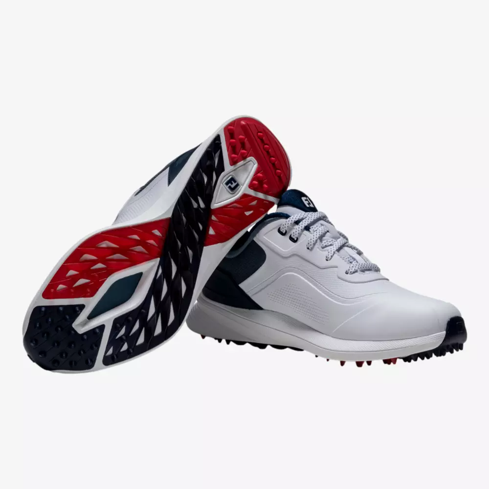 A pair of white athletic shoes with navy and red accents. One shoe is upright, while the other displays the sole, which has a black, red, and white studded tread pattern&mdash;reminiscent of the best Jordan golf shoes.