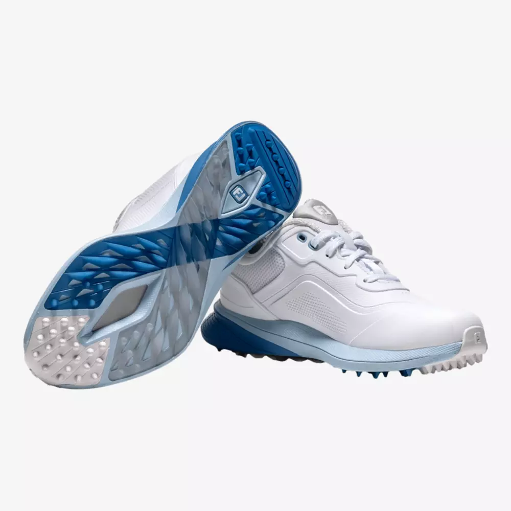 A pair of white athletic shoes with blue soles; one shoe is upright, and the other is angled to show the textured blue and white sole with cleats&mdash;the perfect look for the best golf shoes 2026.