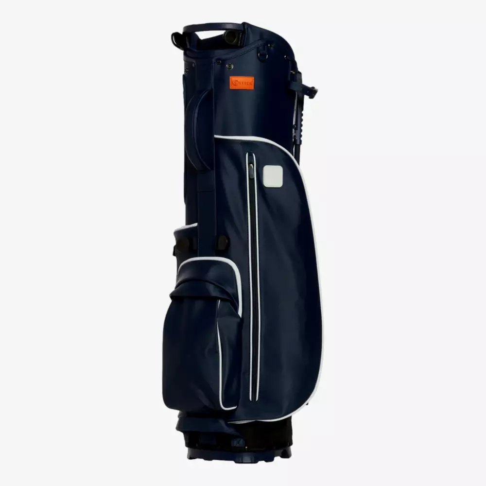 A navy blue golf bag with white trim, multiple zippered pockets, and a handle on top, standing upright against a plain light background&mdash;an ideal contender among the best golf bags 2026.