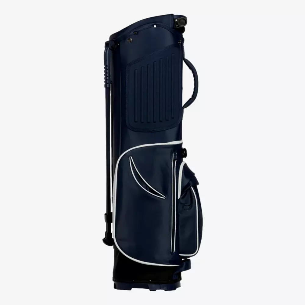 A navy blue golf bag with white trim, featuring a side handle, zippered pockets, and a stand&mdash;an excellent choice for those seeking one of the best golf bags 2026. The bag is upright and photographed against a plain light gray background.
