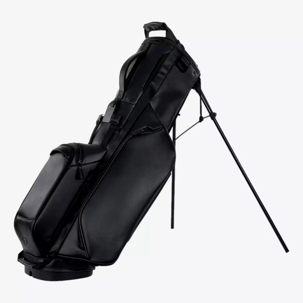 A sleek black golf bag with two extended legs for standing support, multiple zippered compartments, and a padded handle on top&mdash;an ideal pick among the best golf bags 2026 has to offer.