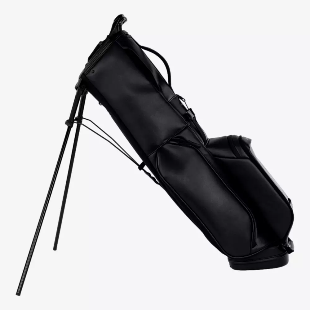 A black golf bag with built-in stand legs extended, positioned upright at an angle on a plain white background&mdash;an example of the best golf bags 2026 has to offer.