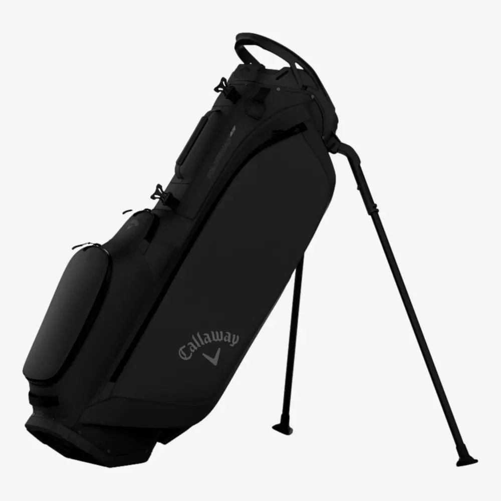 A black Callaway golf bag with stand legs extended, featuring multiple zippered compartments and a carrying handle on top, ranks among the best golf bags 2026, set against a plain white background.