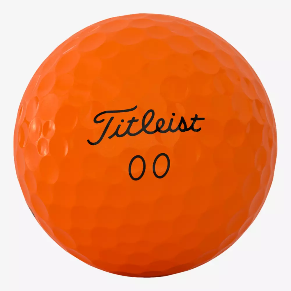 A close-up of an orange Titleist golf ball with the number 00 printed below the brand name in black text&mdash;perfect for your next round in the best golf shoes 2026 has to offer.