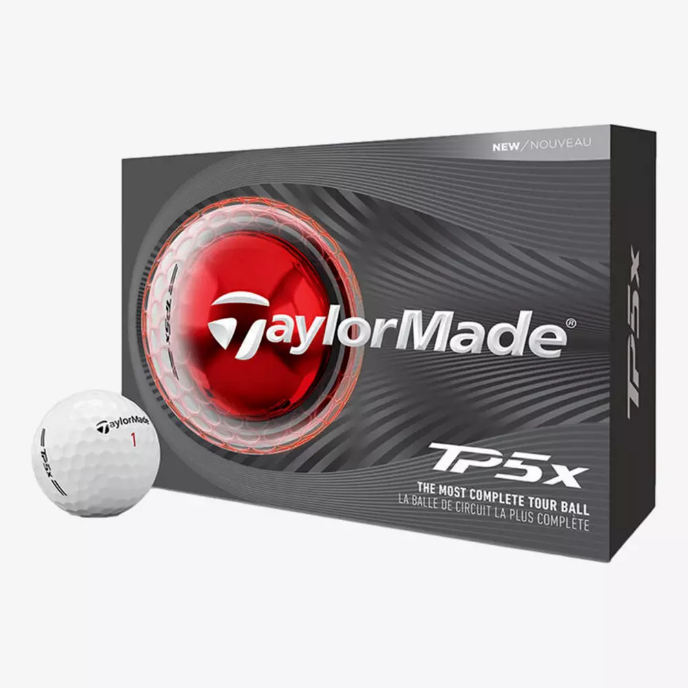 A box of TaylorMade TP5x golf balls is shown, featuring a close-up image of a golf ball and red core on the packaging. One white TaylorMade golf ball sits beside the box&mdash;perfect for pairing with the best golf shoes 2026 has to offer.