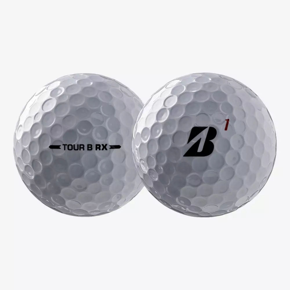 Two white golf balls are shown. One displays TOUR B RX with arrows on each side, and the other features a bold black B with a small red 1 above it. Both have a dimpled surface, making them contenders for the best golf balls 2026.