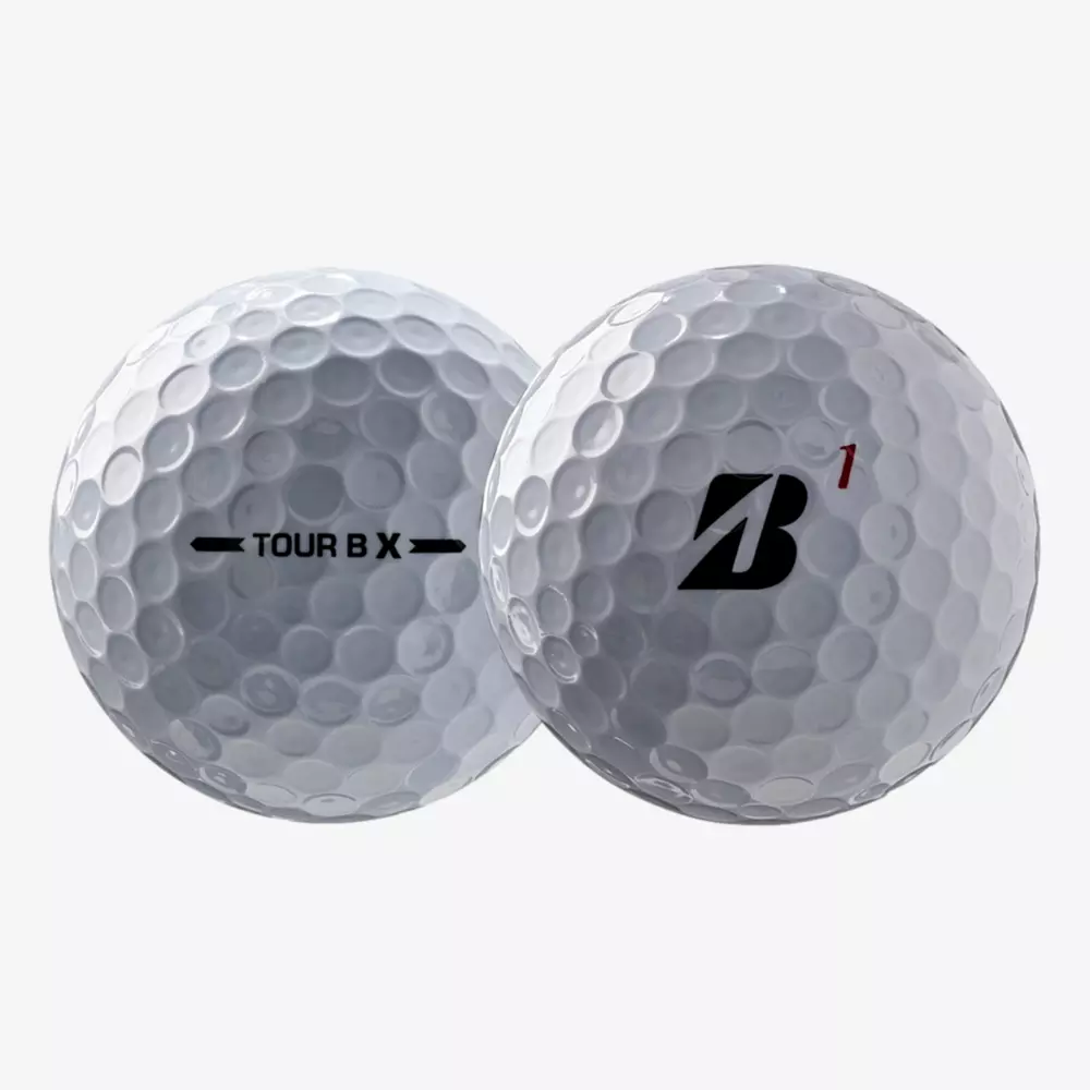 Two white golf balls with dimpled surfaces. One displays TOUR B X in black text, while the other shows a black B logo with a small red 1 above it&mdash;perfect for golfers seeking gear to match the best golf shoes 2026. Both are set against a plain white background.