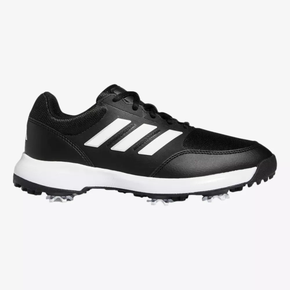 A black Adidas athletic shoe, ideal for those seeking the best golf shoes 2026, with a white sole, iconic white stripes on the side, black laces, and small spikes on the outsole, viewed from the side against a white background.