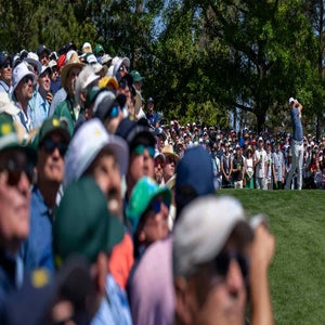 Rory McIlroy of Northern Ireland is framed by Masters patrons as he plays a stroke from the No. 4 tee during the final round of the Masters at Augusta National Golf Club, Sunday, April 13, 2025. (Photo by Joel Marklund/Augusta National/Getty Images)