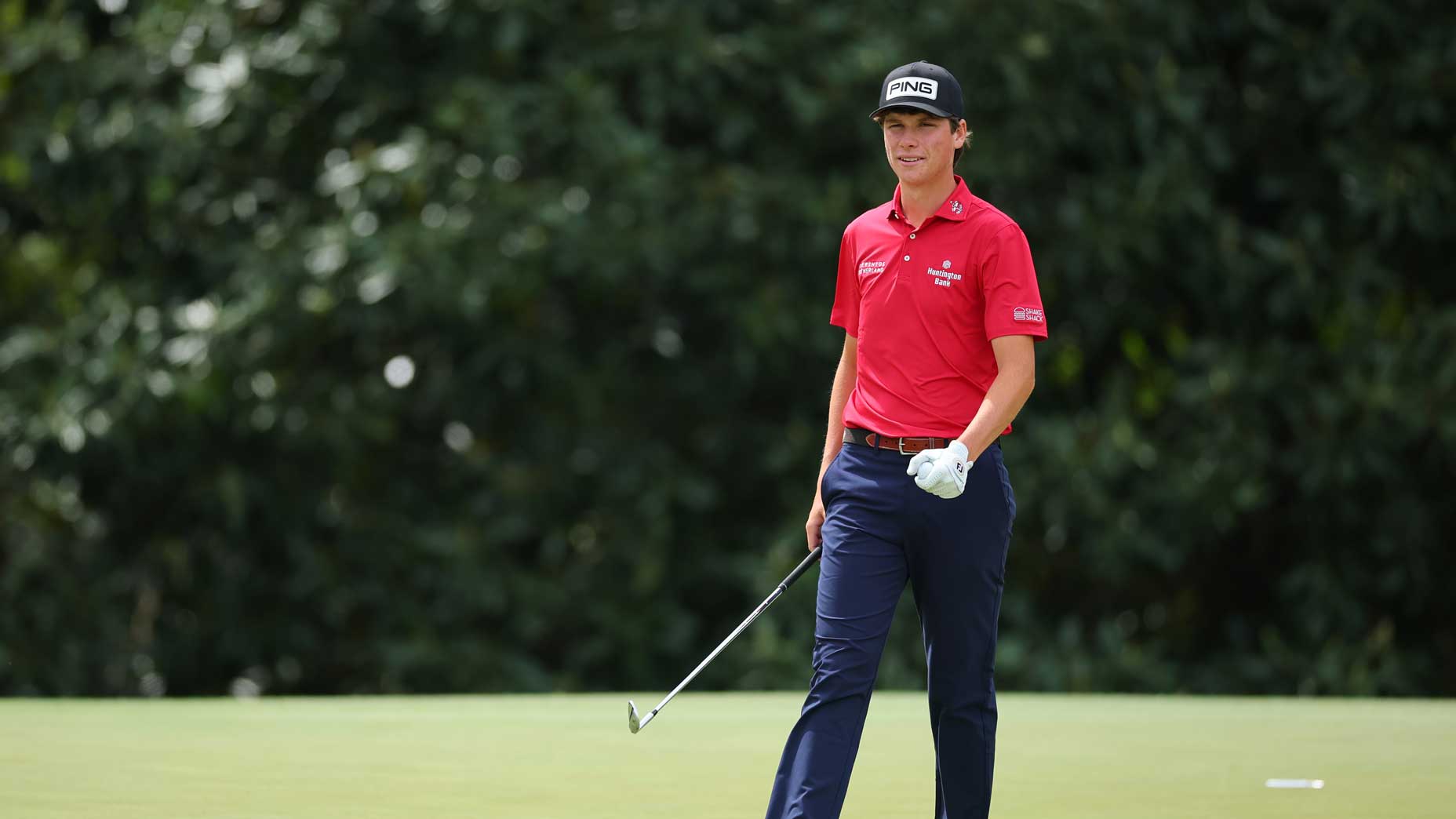 Mason Howell walks across green during a practice round at Augusta National