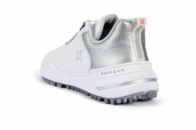 A white athletic shoe with silver accents, a textured sole for grip, and PMX FOAM printed on the side&mdash;one of the best golf shoes 2026&mdash;shown from the back angle against a white background.