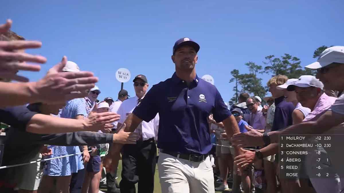 Bryson DeChambeau embraces fans at the Masters