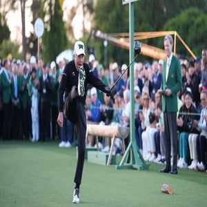 Gary Player kicks the air after his ceremonial tee shot at the Masters