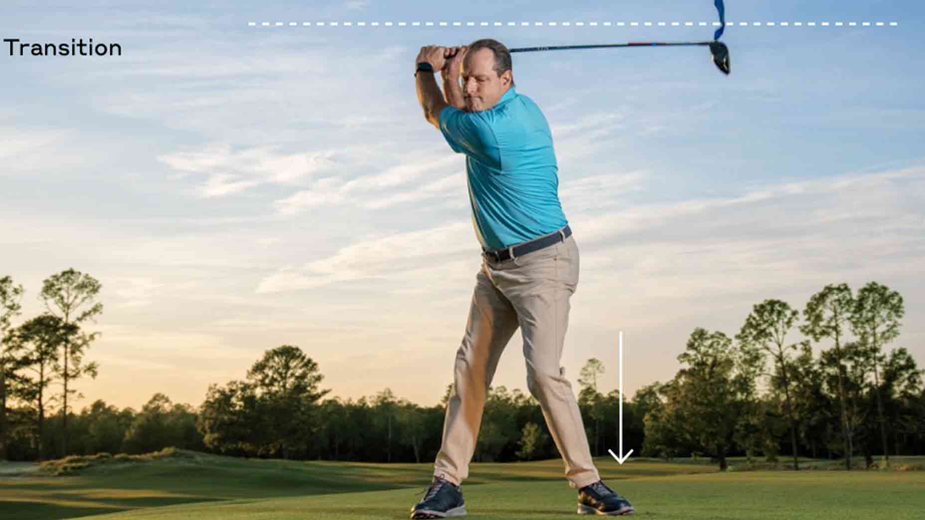 A pressure player in a blue shirt and beige pants stands on grass, mid-backswing with a club, as white dashed and arrow lines highlight transition points to help him hit more bombs. Trees and a blue sky form the backdrop.