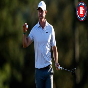 A male golfer in a white Nike polo holds up a golf ball and carries a putter, standing on a golf course with a focused expression. A red Tour Confidential logo is in the top right corner.